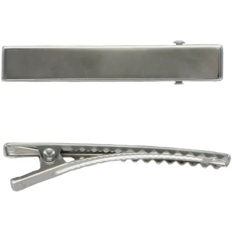 Top view of a silver metal tie clip from Shop Acre Goods with a smooth, rectangular surface; the side view shows its alligator-like textured grip used to secure it to a tie.